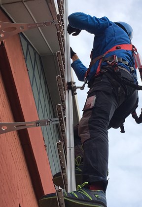 Fixed ladder with rail and fall protection