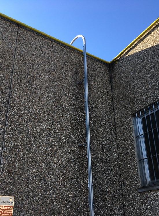 Fixed ladder with rail and fall protection