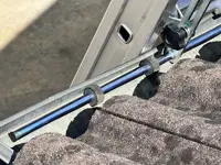 Accesorio de fijación de escalera en su parte superior a: bordes, vallas publicitarias, canalones 